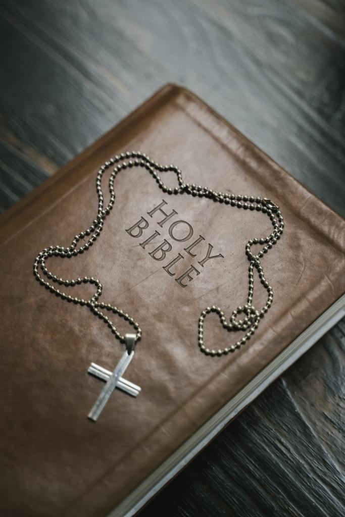 The Holy Bible and a necklace with the Cross
