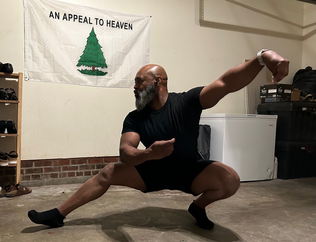 Over 40 man demonstrating a lou lunge position for Tai-Chi.