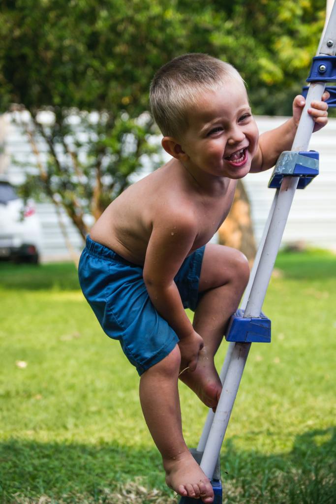 Little boy climbing ladder